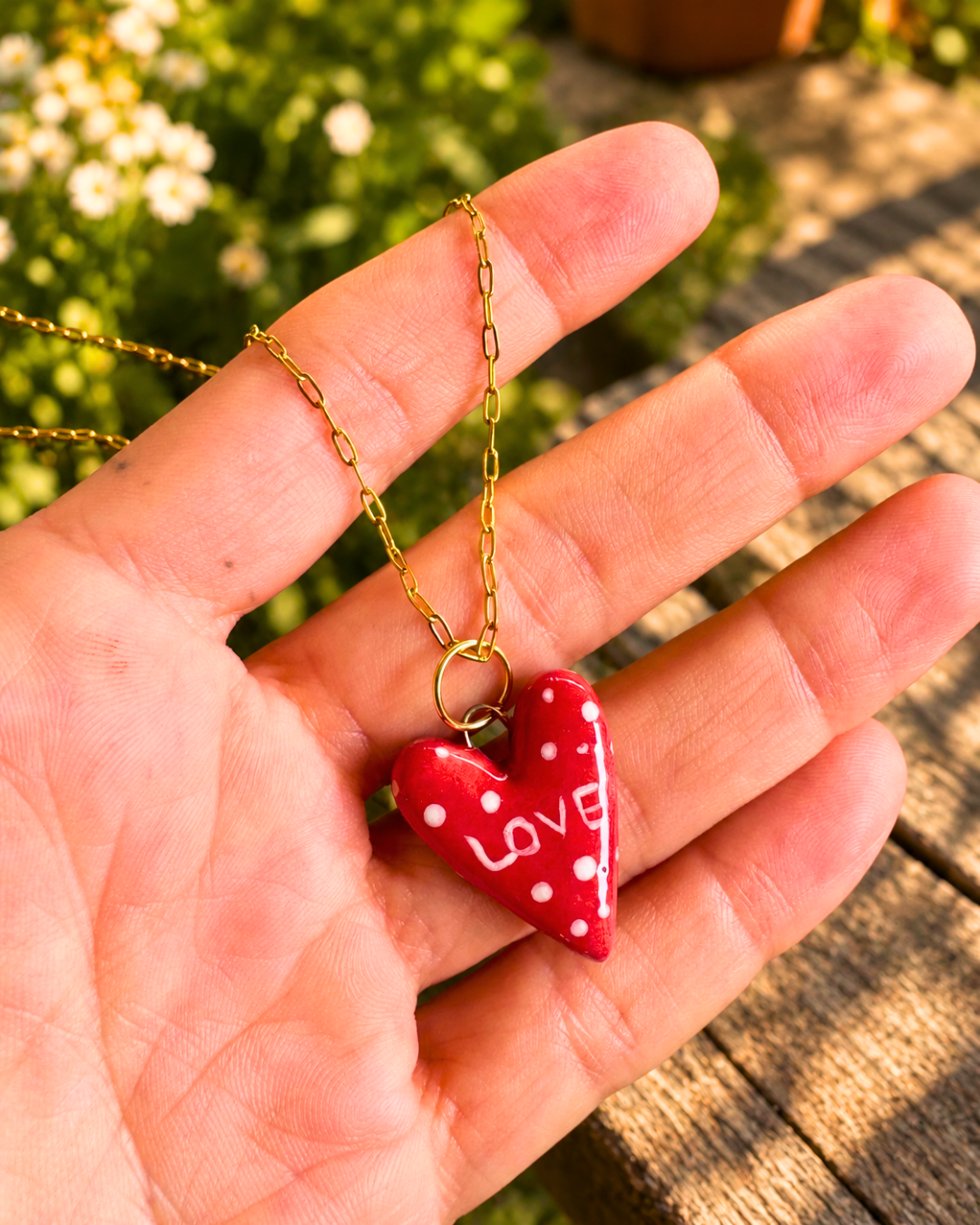 Dettaglio del ciondolo a cuore rosso a pois LOVE
